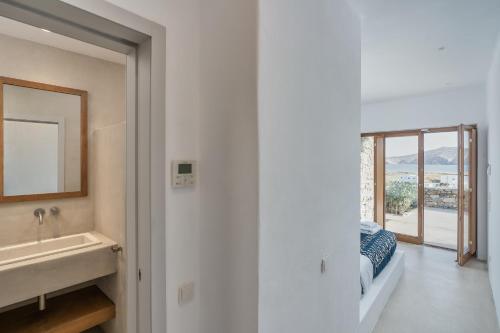 a bathroom with a sink and a mirror at Christina's Panormos Villa in Mykonos