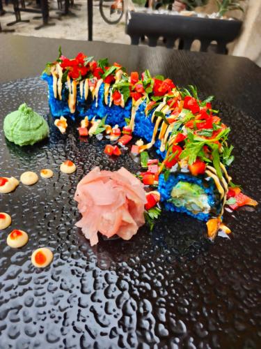 a cake on a black table with some food on it at Luxury Rooms "Kaleta" in Trogir
