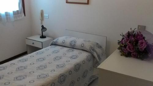 En eller flere senger på et rom på Albergo Villa Garda