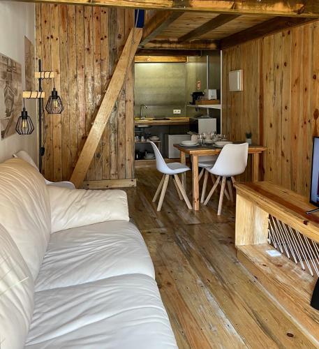 a bedroom with a bed and a table and chairs at Casas do Miradouro in Setúbal