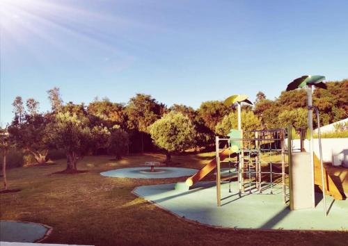 a playground with a slide in a park at Lujoso aprtamento cap tingis playa tanger in Tangier