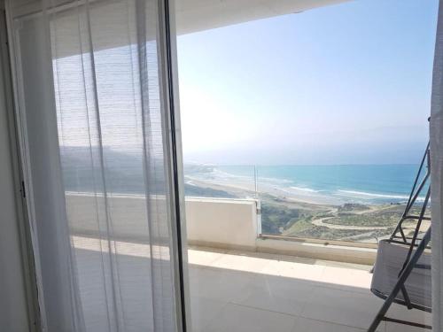 a view of the ocean from a room with a window at Lujoso aprtamento cap tingis playa tanger in Tangier