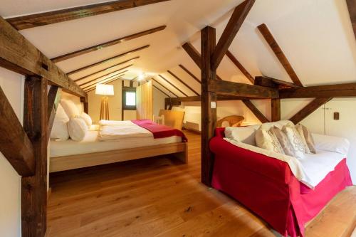 two beds in a room with wooden beams at Ganzes Haus mit großem Garten und eigener Sauna in Unterwössen