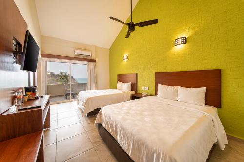 Postel nebo postele na pokoji v ubytování Villas Coral Huatulco