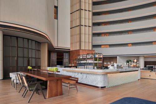a lobby of a hotel with a table and chairs at Sheraton Rizhao Hotel in Rizhao