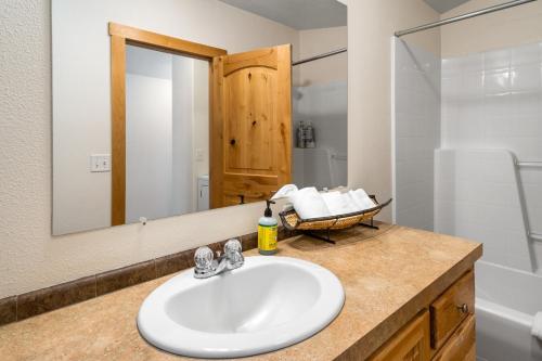 a bathroom with a white sink and a mirror at Alpine #1 in West Yellowstone