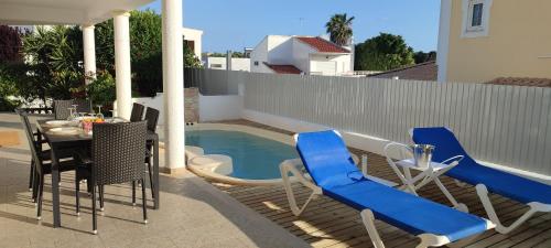 a patio with a table and chairs and a pool at Casa da Amoreira by ALgest in Alvor