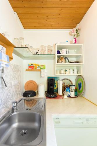 a small kitchen with a sink and a counter at Gaestehaus Richter in Oberammergau