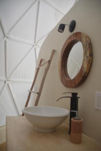 a bathroom with a sink and a mirror on a counter at Glamping Mayan Glam in Tulum