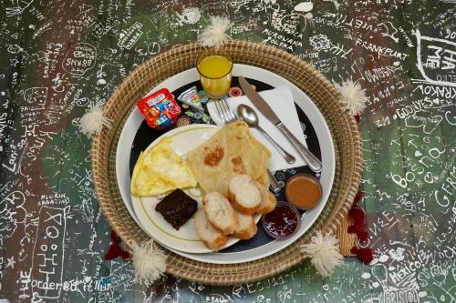 a plate of breakfast food on a table at The Madrassa Hostel in Marrakech