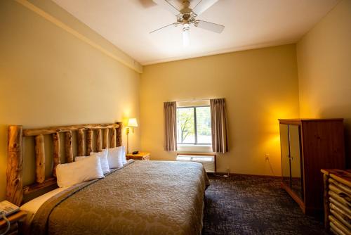 a bedroom with a bed and a window at Super 8 by Wyndham Bridgeview of Mackinaw City in Mackinaw City