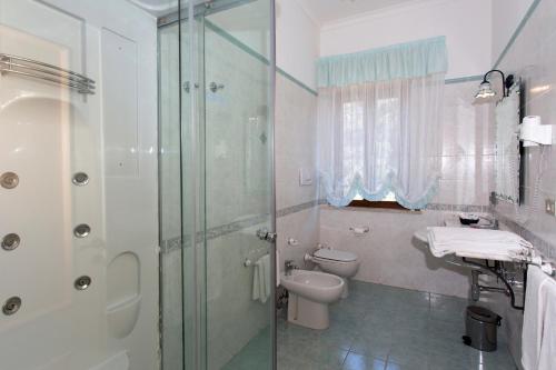 a bathroom with a shower and a toilet and a sink at Fico D'India Relais in Furore