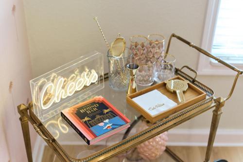 a glass table with a book and other items on it at Luxury Villa 3 Blocks from the Beach with Pool a Fire Pit and Outdoor Oasis in Cape Canaveral