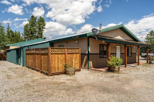 a house with a wooden fence in front of it at Alpine #2 in West Yellowstone