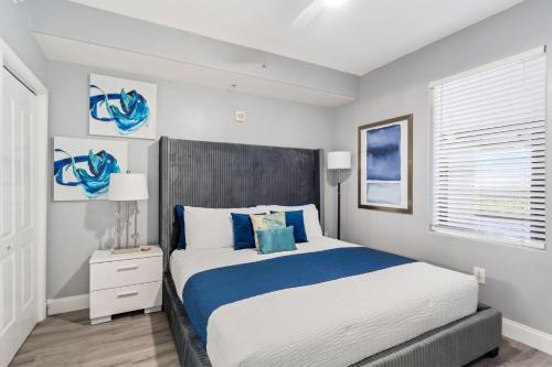 a bedroom with a large bed with blue accents at Blue Heron Beach Resort in Orlando