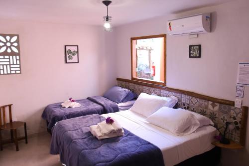 En eller flere senge i et værelse på Pousada Luz dos Olhos