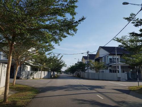 an empty street with houses and a fence at Selendang - Near Std Hang Jebat, MITC & UTEM in Melaka