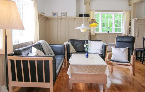 a living room with a couch and a table at Awesome Home In Gudhjem With Wifi in Gudhjem