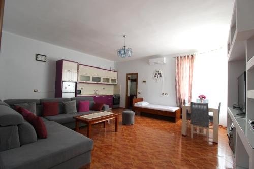 a living room with a couch and a table at Garden Vila Ermali in Ksamil