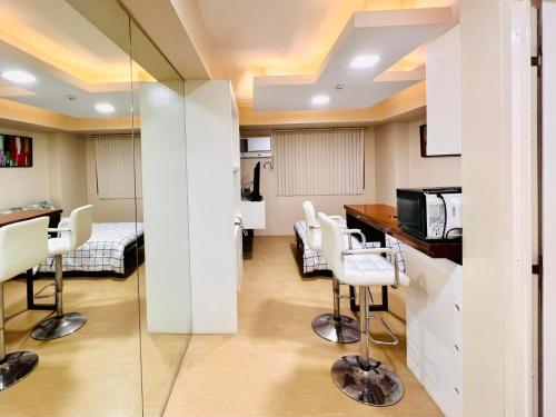 a room with a kitchen and a living room at D Peaceful and Comfortable Room in Iloilo City