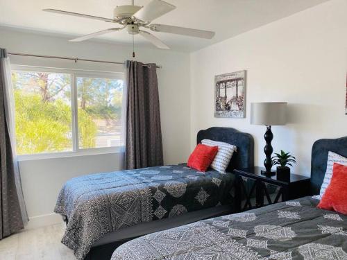 a bedroom with two beds and a window at Dreamy Palm Springs Villa w Pool, Spa, Great Views in Palm Springs