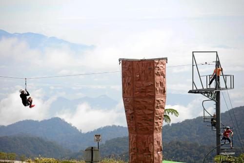 a person jumping off of a zip line at Sky Retreat Genting Highlands in Genting Highlands