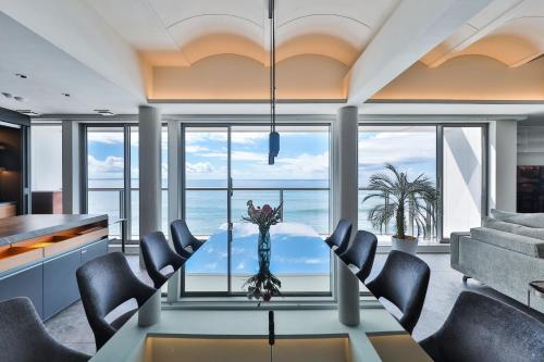 a dining room with a view of the ocean at 3rd House Inamuragasaki in Kamakura