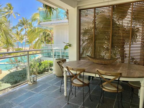 a dining room with a table and chairs on a balcony at Stunning Beachfront Condo With Private Beach, Las Terrenas-El Limón in El Limón