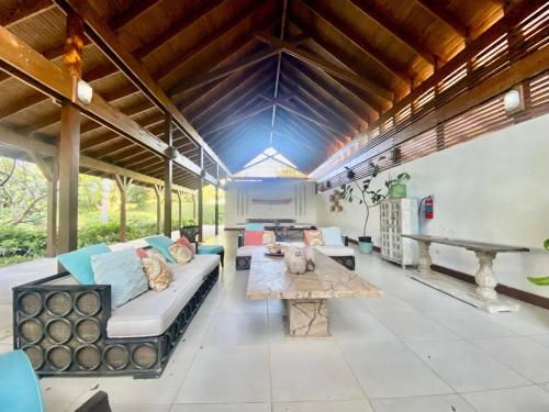 a living room with a couch and a table at Stunning Beachfront Condo With Private Beach, Las Terrenas-El Limón in El Limón