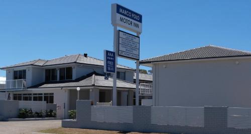 a street sign in front of a house at Marco Polo Motor Inn Taree in Taree