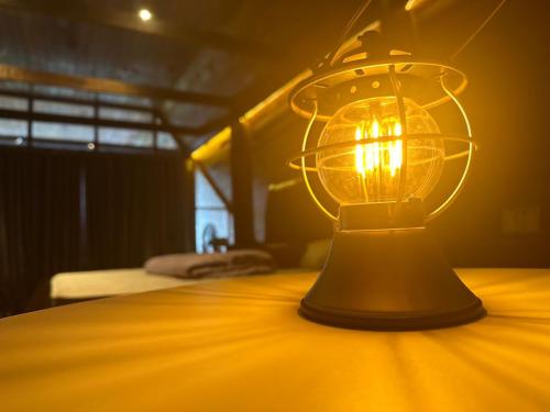 a lamp sitting on a table in a room at SANKARA GARDEN in Pantai