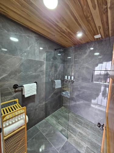 a bathroom with a shower with a glass door at Wind Houses, Casas de Viento in Monteverde Costa Rica