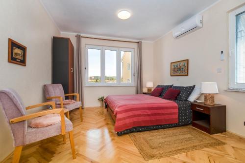 a bedroom with a bed and a table and chairs at KAIROS in Bilice