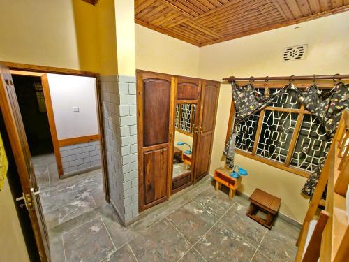an empty room with a door and a window at Mazzola Safari House & Backpacking in Arusha