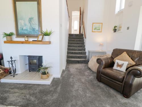 a living room with a couch and a fireplace at Minerva in Holyhead