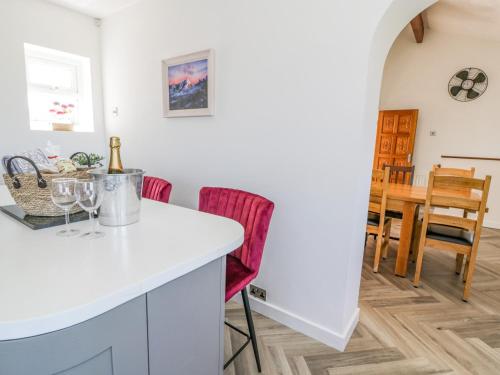 a kitchen and dining room with a table and chairs at Minerva in Holyhead