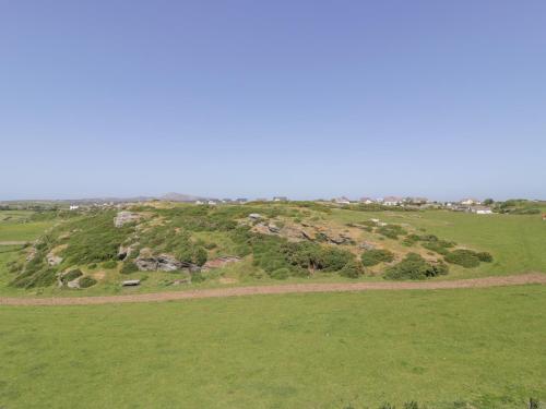 a grassy hill with rocks on top of it at Minerva in Holyhead