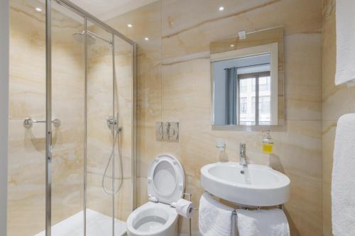 a bathroom with a toilet and a sink and a shower at Central Savona in Savona