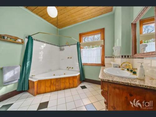 a large bathroom with a tub and a sink at Sorell Barracks in Sorell