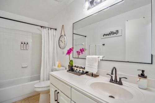 a bathroom with a sink and a toilet and a mirror at Pet Friendly Home by Katy in Houston