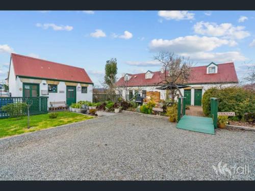 a house with a red roof and a playground at Sorell Barracks in Sorell