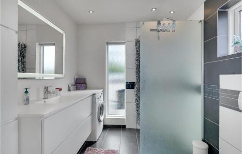 a bathroom with a sink and a washing machine at Beautiful Home In Faaborg With Jacuzzi in Fåborg
