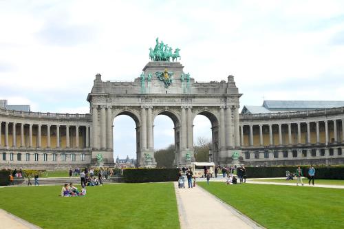 a large building with a statue in front of it at Budget Flats Brussels in Brussels