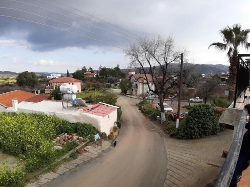 a winding road in a small town with houses at THE ROCK HOUSE - Beautiful countryside with mandarins oranges and olive trees,. Near Limassol at Eptagonia village. in Ephtagonia