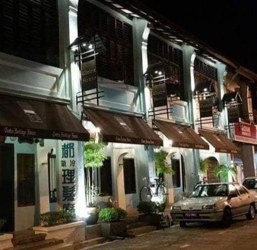 a car parked in front of a building at night at Cintra House in George Town