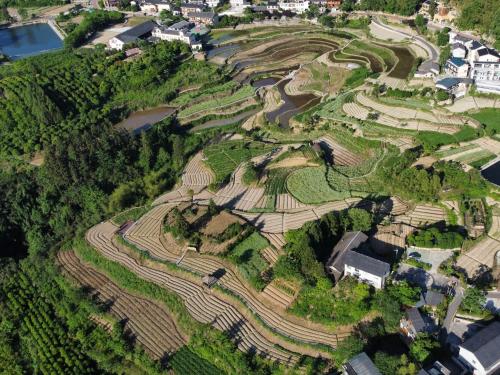 an aerial view of a garden with trees and buildings at Zhangjiajie National Park Nvue Resorts in Zhangjiajie