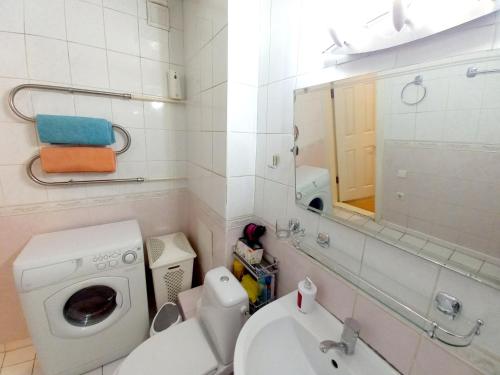 a bathroom with a washing machine and a sink at "Золотой Квадрат" Центр Квартира - "Golden Square" Apart in Almaty