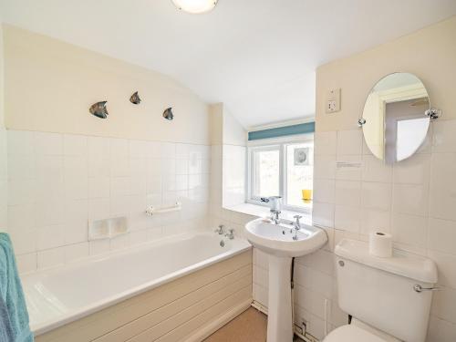 a white bathroom with a tub and a sink at Waingap in Crook