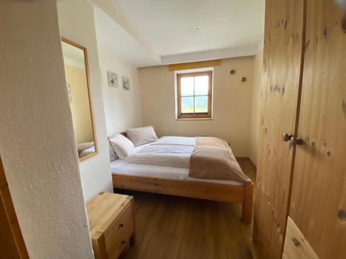 a small bedroom with a bed and a window at Apartments Golfweg in Kitzbühel
