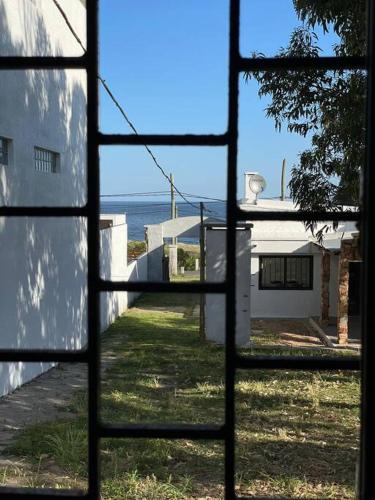 a view from a window looking out at the ocean at Casa Alquiler Cuchilla Alta 2 in Cuchilla Alta